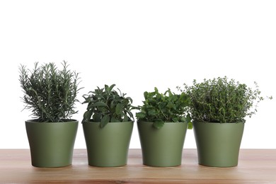 Pots with thyme, sage, mint and rosemary on wooden table against white background