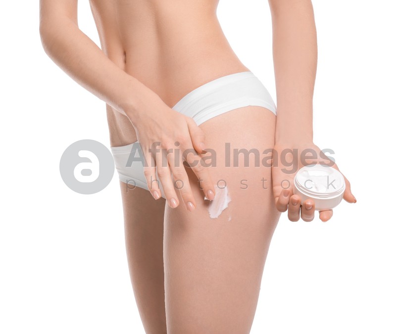 Young woman with jar of body cream on white background
