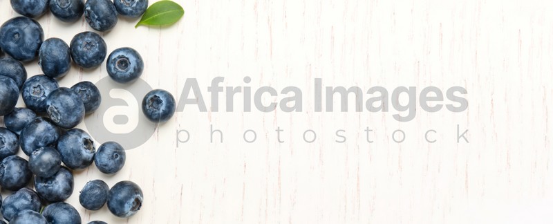 Tasty fresh blueberries on white wooden background, top view with space for text. Banner design