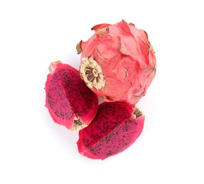 Delicious cut and whole red pitahaya fruits on white background, top view