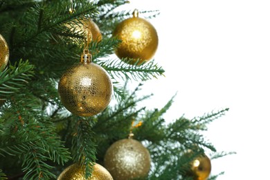 Christmas tree with golden baubles on white background, closeup