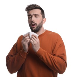 Sick man sneezing on white background. Cold symptoms
