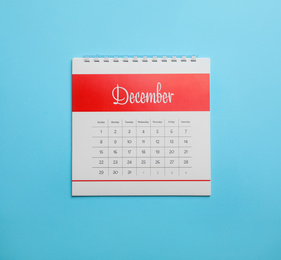 December calendar on light blue background, top view
