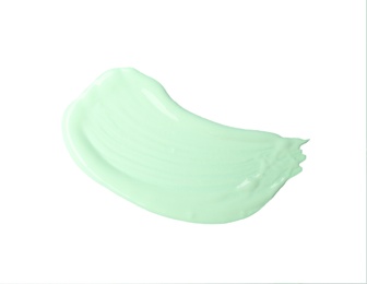 Stroke of green color correcting concealer isolated on white