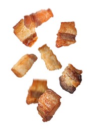 Image of Tasty fried cracklings falling on white background. Cooked pork lard