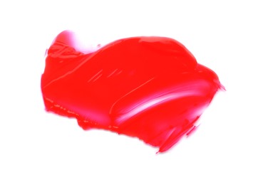 Red paint sample on white background, top view