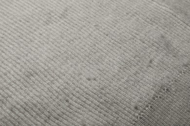 Photo of Light cloth with bobbles, closeup. Before use of fabric shaver