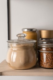 Flour and buckwheat in glass jars on shelf