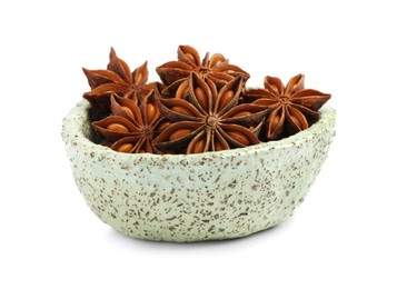 Bowl with dry anise stars on white background