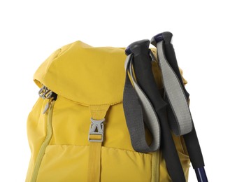 Trekking poles and yellow backpack on white background