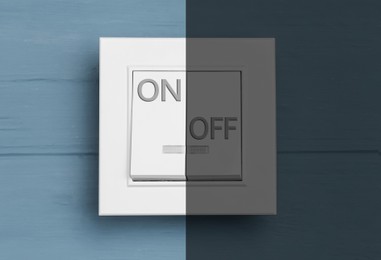 Image of Turned ON and OFF light switch on blue wooden background