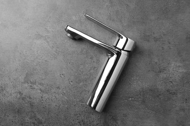 Single handle water tap on grey table, top view