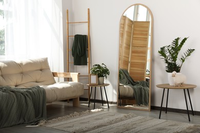 Stylish room interior with leaning floor mirror