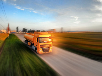 Logistics concept. Truck on country road, motion blur effect 
