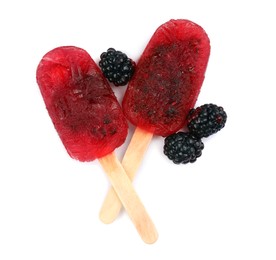 Delicious ice pops and fresh blackberries on white background, top view. Fruit popsicle