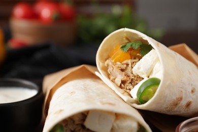 Photo of Delicious tortilla wraps with tuna, cheese and vegetables, closeup