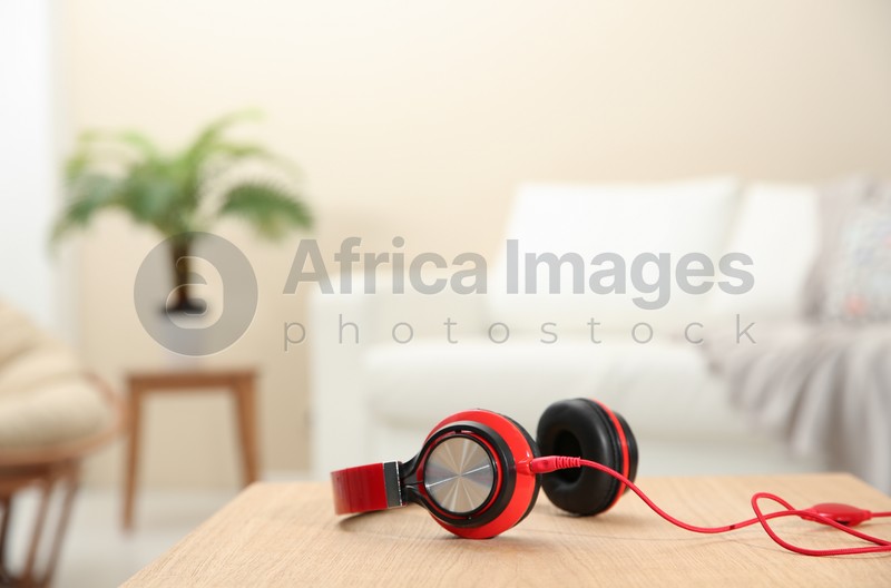 Stylish headphones on table indoors. Space for text