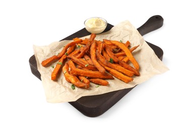 Photo of Board with delicious sweet potato fries and sauce on white background