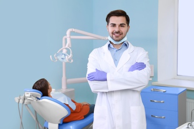 Professional dentist and patient in modern clinic