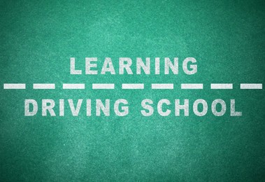 Driving school concept. Text and dashed line on green chalkboard 