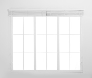 Window with white open blinds in room