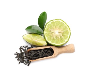 Dry bergamot tea leaves, wooden scoop and fresh fruit on white background, top view