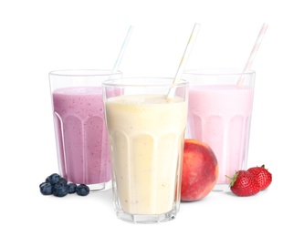 Different tasty milk shakes and fruits isolated on white