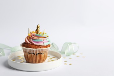 Cute sweet unicorn cupcake on white background, space for text