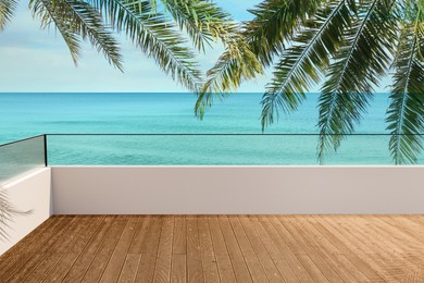 Image of Outdoor wooden terrace under palm trees revealing picturesque view on ocean