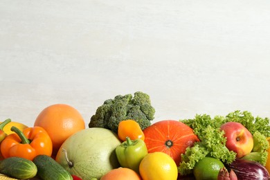 Photo of Assortment of fresh organic fruits and vegetables on light background, closeup. Space for text