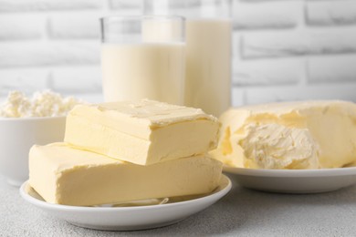Photo of Tasty homemade butter and dairy products on white textured table
