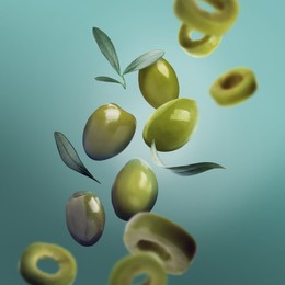 Image of Fresh olives and leaves falling on turquoise background