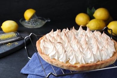 Delicious lemon meringue pie on black table