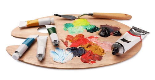 Photo of Wooden palette with oil paints and palette knife on white background