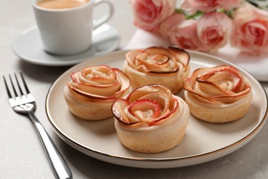 Freshly baked apple roses served on light table. Beautiful dessert
