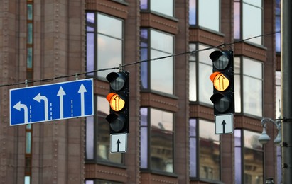 View of traffic lights and road signs in city