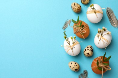 Photo of Festively decorated eggs on light blue background, flat lay and space for text. Happy Easter