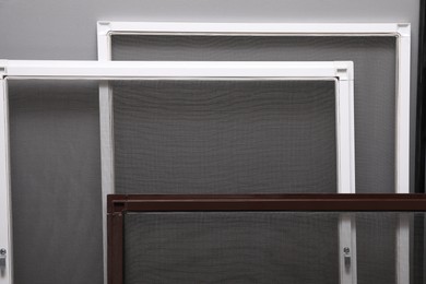 Mosquito window screens near grey wall, closeup