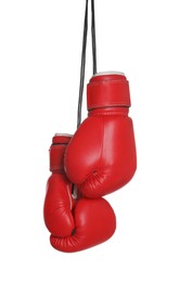 Pair of boxing gloves hanging on white background