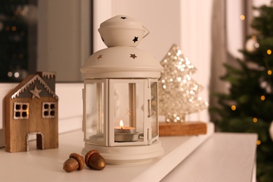 Photo of Decorative Christmas lantern with burning candle on windowsill