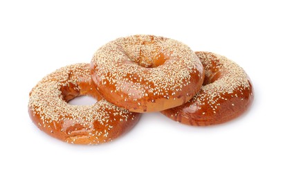 Delicious fresh bagels with sesame seeds on white background