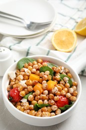 Delicious fresh chickpea salad on light grey marble table