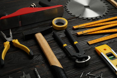 Different carpenter's tools on black wooden background