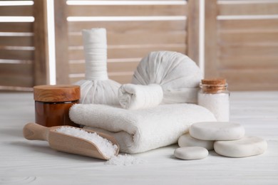 Spa composition with skin care products on white wooden table
