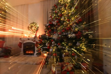 Festive living room interior with Christmas tree and fireplace, long exposure effect
