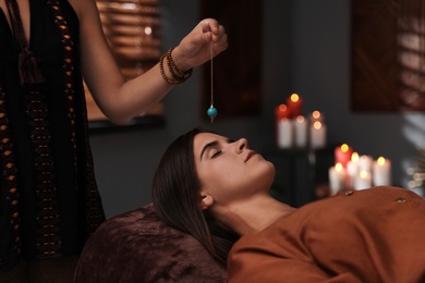 Woman at crystal healing session in dark room