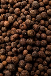 Aromatic allspice grains as background, top view