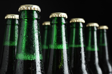 Photo of Bottles of beer on dark background, closeup