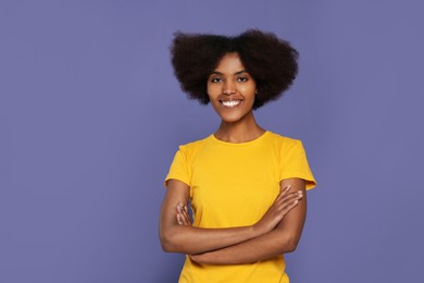 Photo of Portrait of smiling African American woman on purple background. Space for text