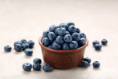 Tasty fresh blueberries on light table, closeup